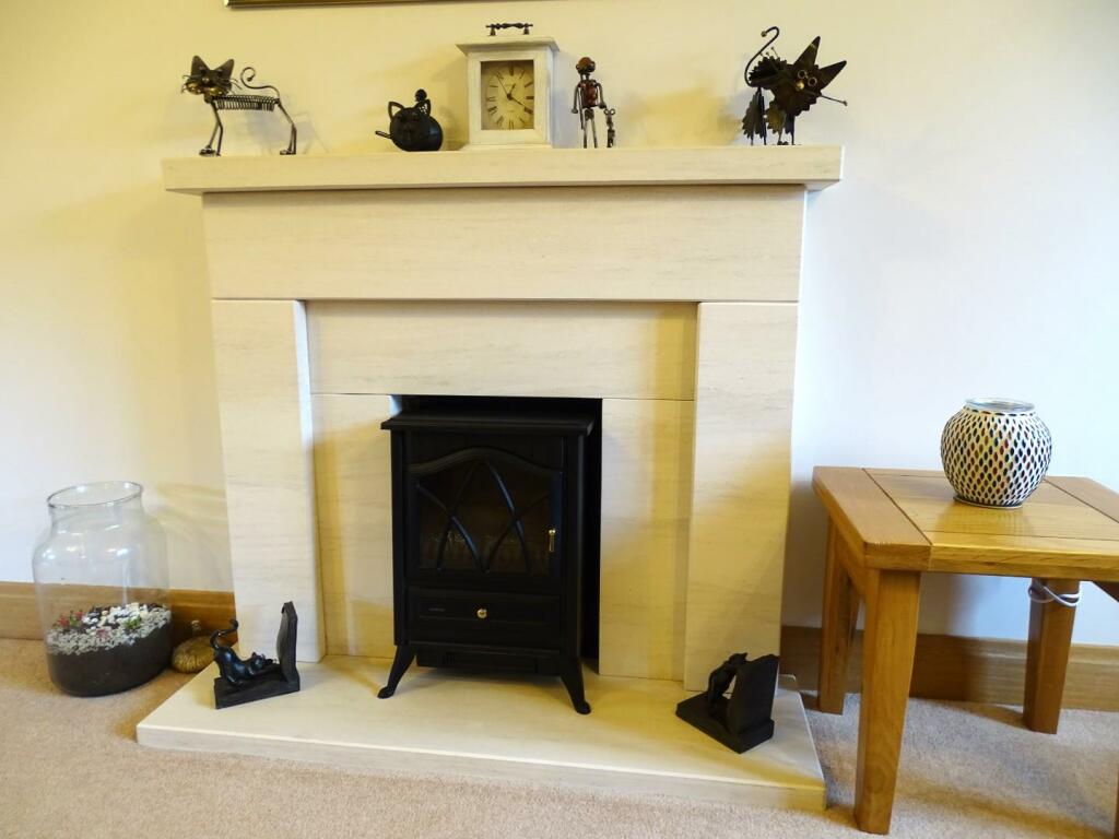 FEATURE LIMESTONE FIREPLACE