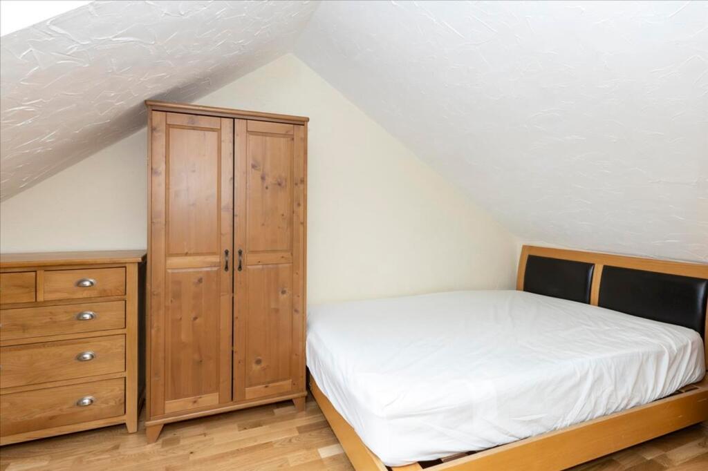 This inviting double bedroom features a cozy wo...