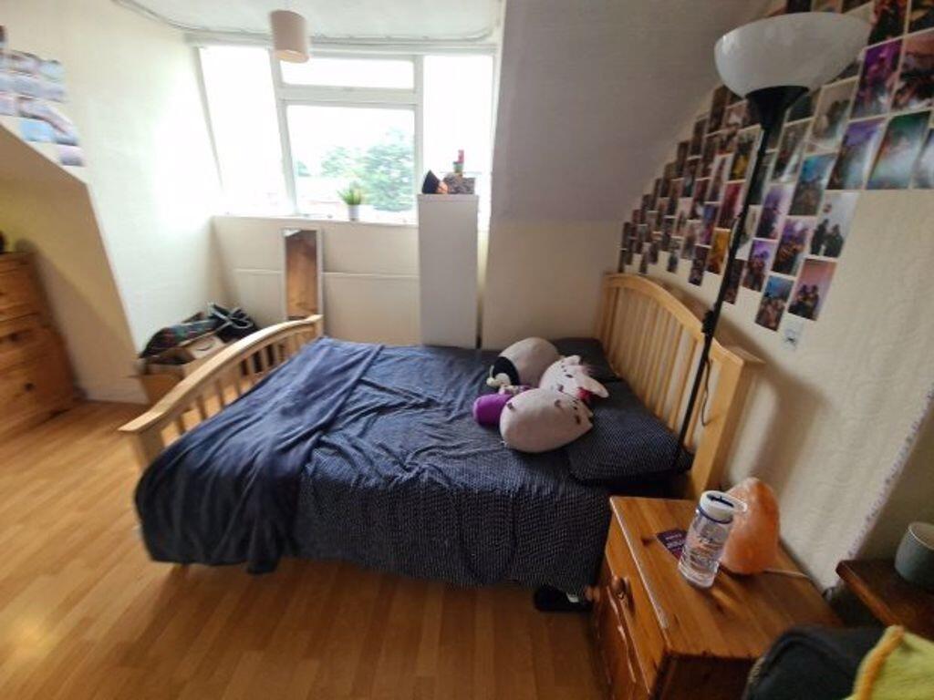 Cozy double bedroom featuring a comfortable woo...