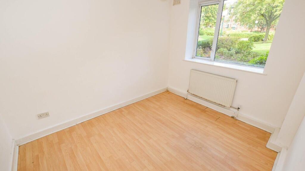 Bright room with a large window overlooking a g...