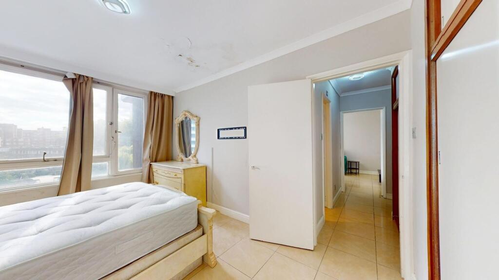 Bright and airy bedroom with large windows lett...