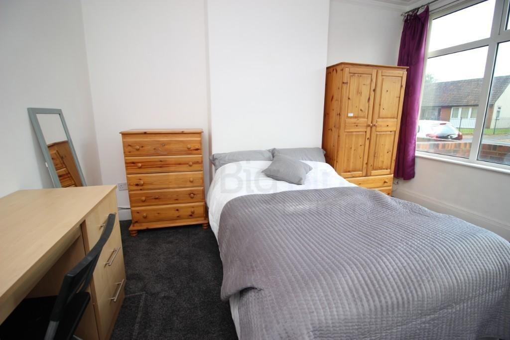 Bright and cozy single bedroom featuring a comf...