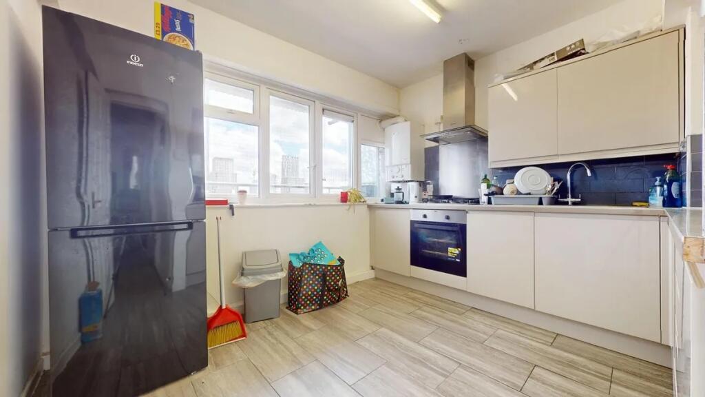 Modern kitchen with sleek cabinetry, built-in o...