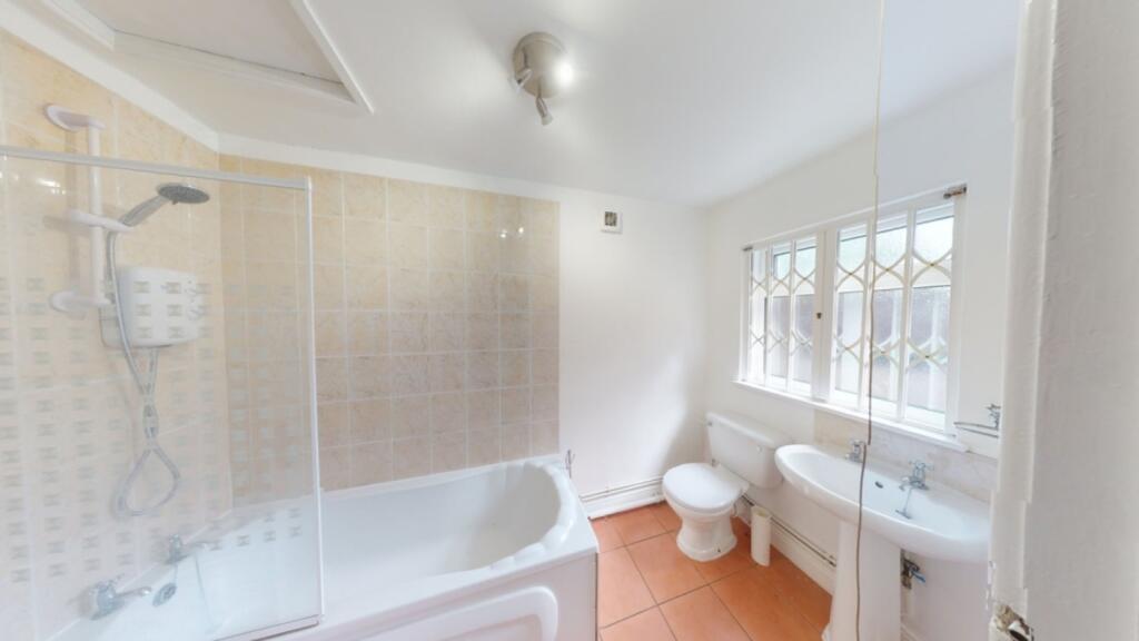 A spacious and bright large bathroom featuring ...
