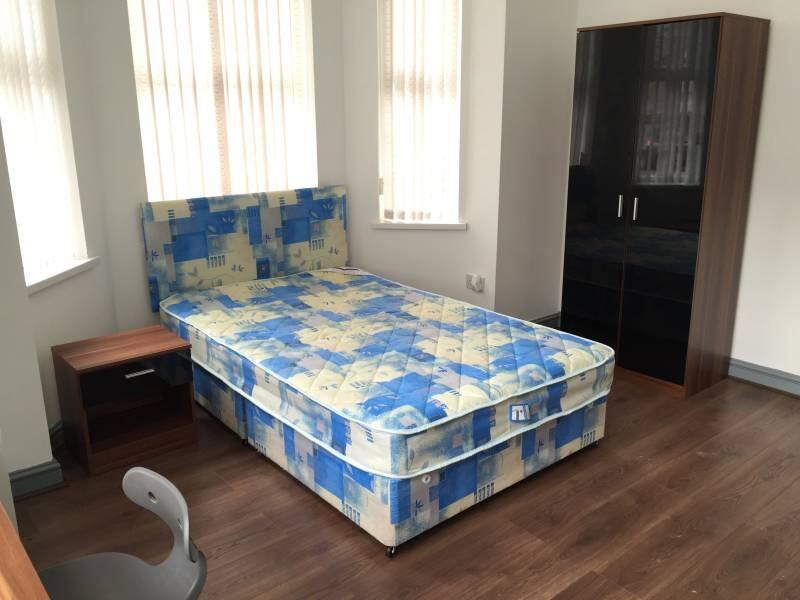 Bright furnished bedroom with a patterned doubl...