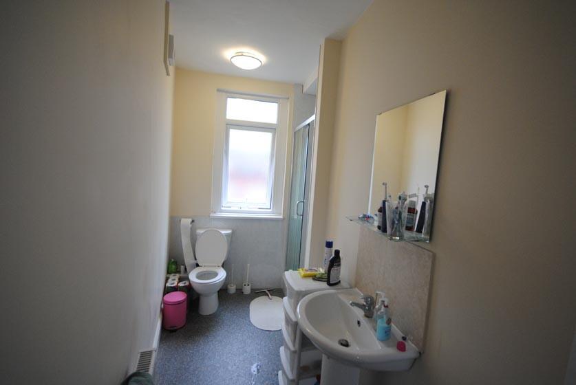 Clean, simple bathroom with a sink, toilet and ...