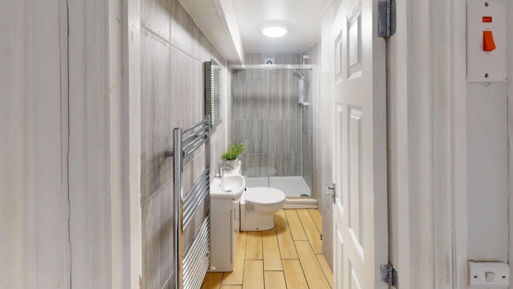 A modern bathroom featuring a white toilet and ...