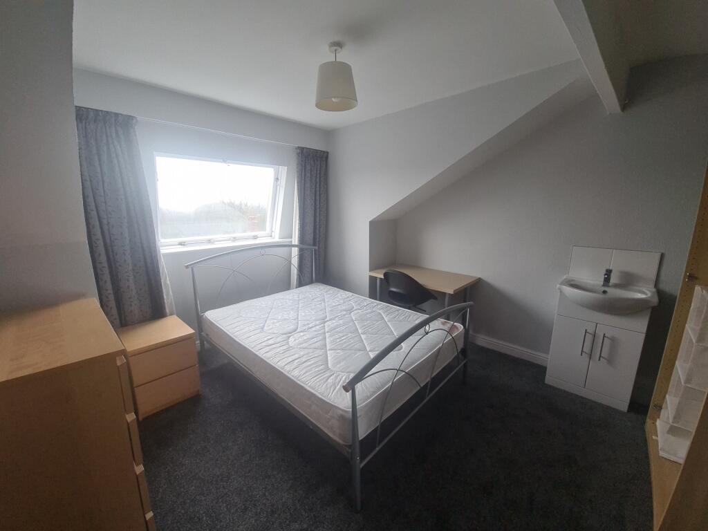 A neat single bedroom featuring a cosy single b...