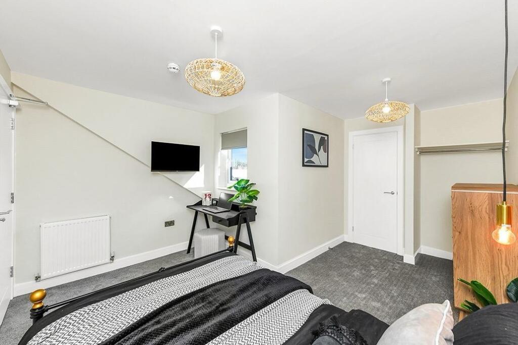 A modern double bedroom featuring stylish decor...