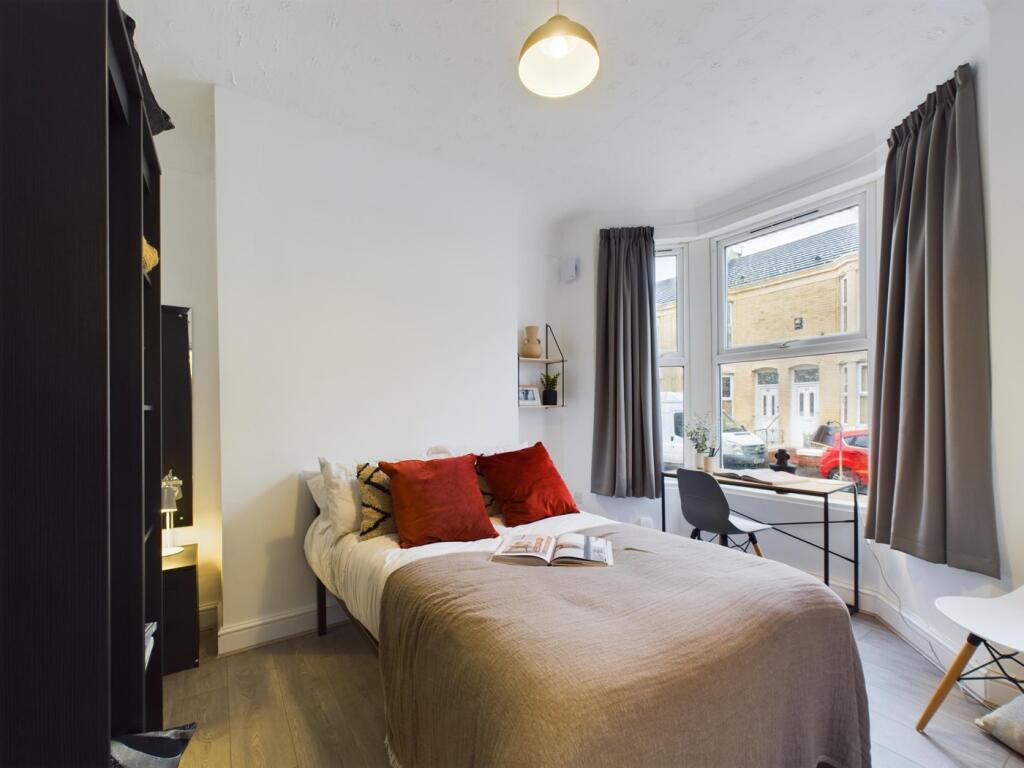 A bright and inviting double bedroom featuring ...