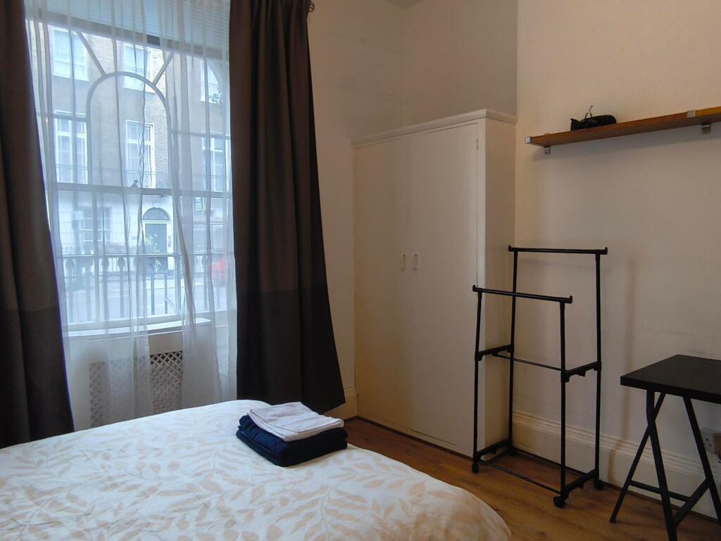 Bright and inviting bedroom featuring large win...