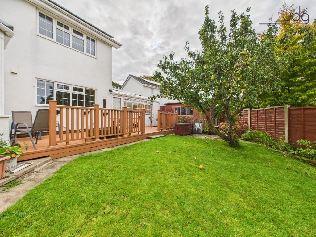 Spacious garden to the rear of the property with decking and fruit trees