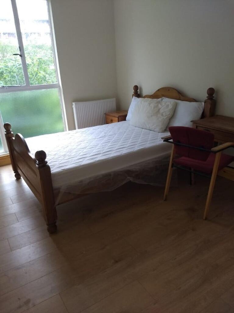 A bright and inviting double bedroom with a lar...