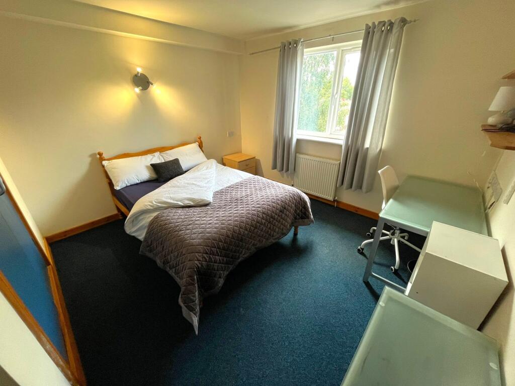 A spacious and inviting double bedroom featurin...