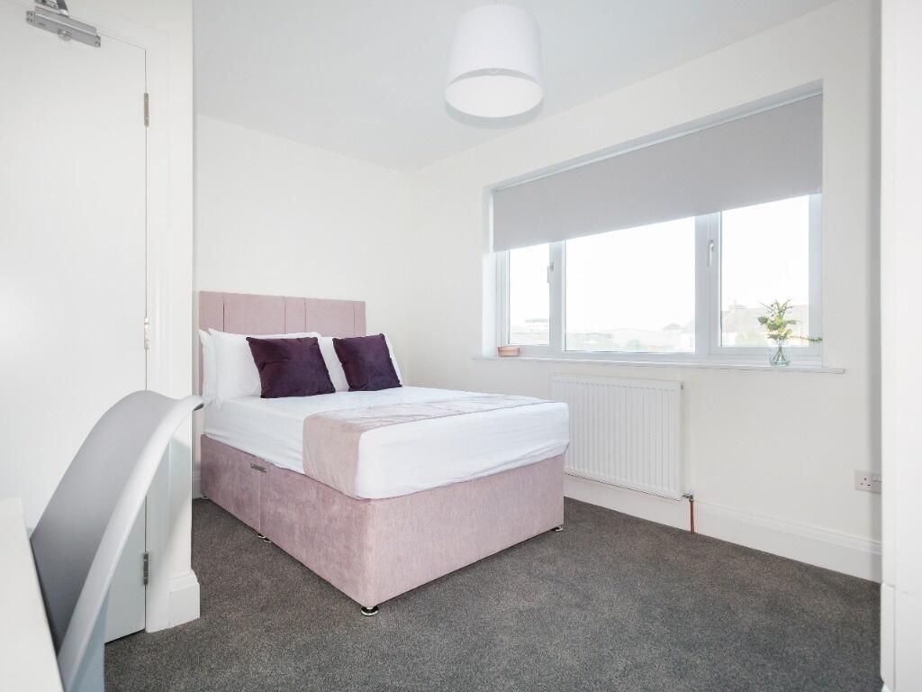 Bright and modern double bedroom featuring a co...