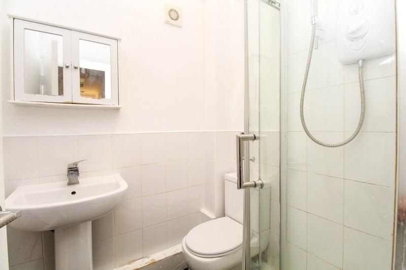 A clean and functional bathroom featuring a ped...