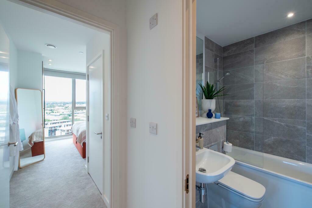 A modern bathroom featuring elegant large grey ...