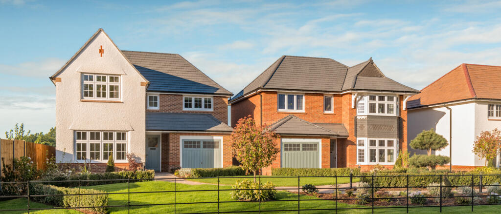 Modern detached houses with well-maintained gardens and driveways, located in a suburban neighbourho