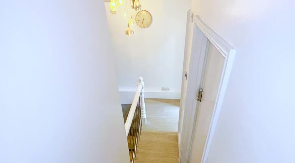 A well-lit and clean staircase featuring modern...