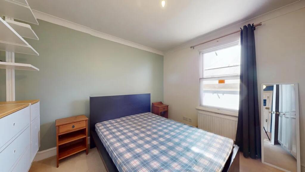 Bright and tidy double bedroom featuring a larg...