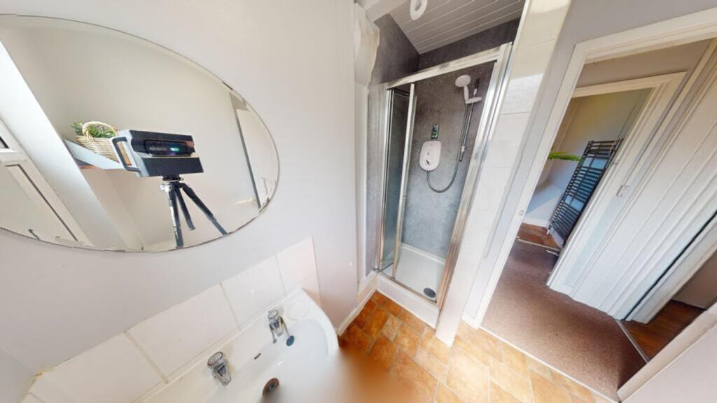 A bright and tidy bathroom featuring a shower a...