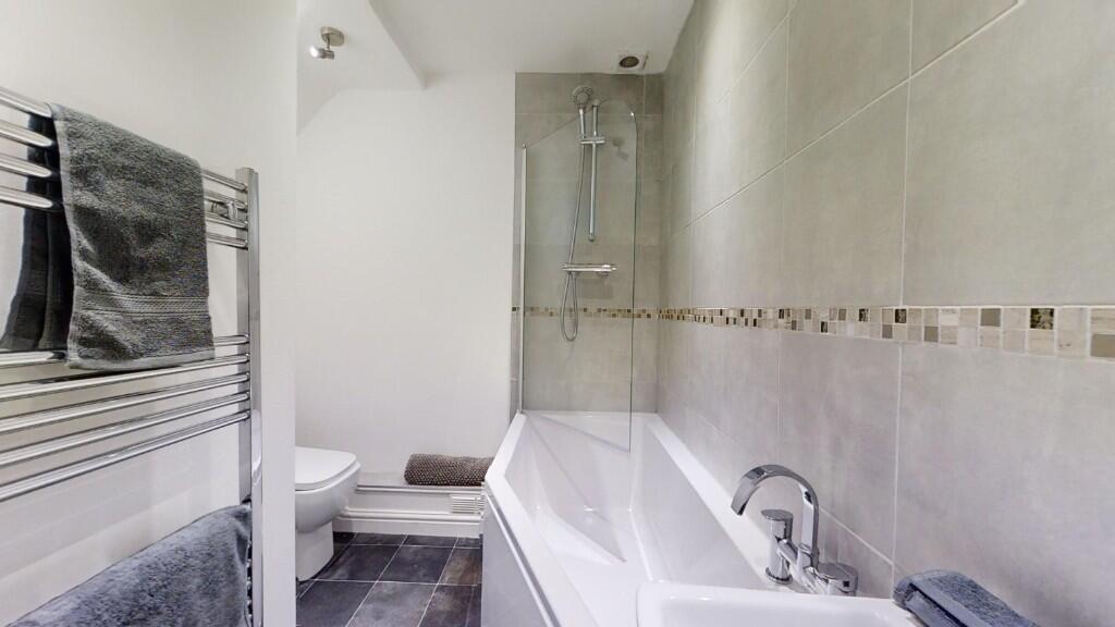 A modern bathroom suite featuring a spacious ba...