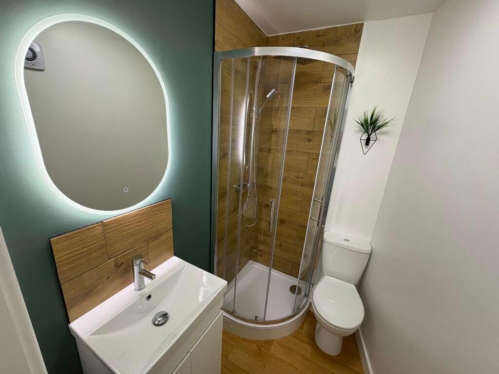 A modern bathroom featuring a stylish illuminat...