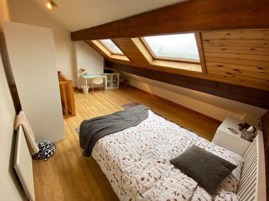 Bright attic bedroom with sloped ceilings, two ...