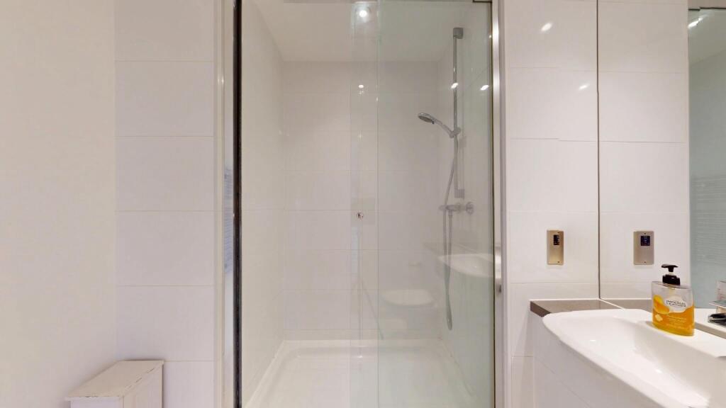 A modern and spotless bathroom featuring a larg...