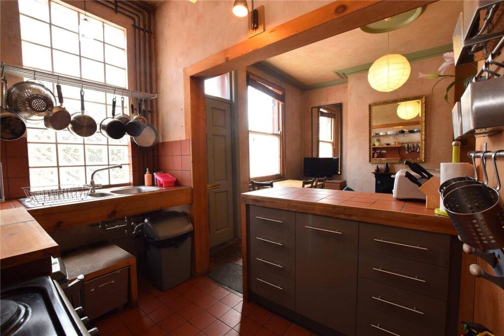 A charming kitchen featuring warm wooden cabine...
