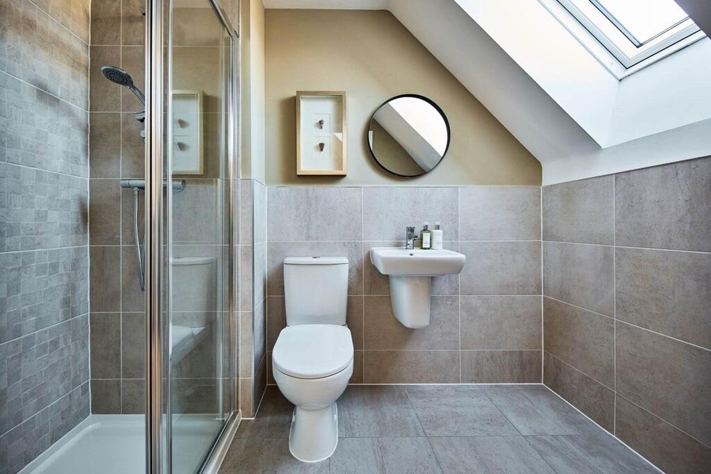 The en-suite benefits from a large double shower
