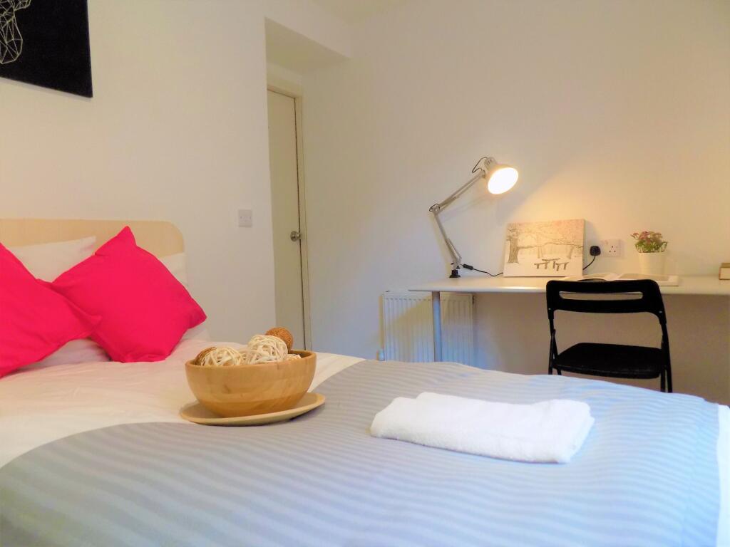 Bright and tidy single bedroom featuring a cozy...