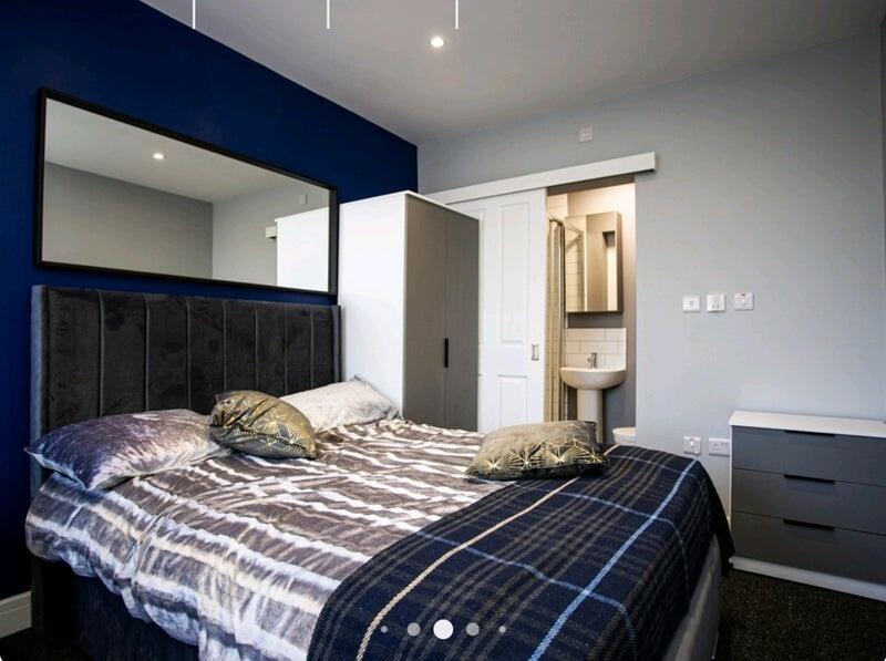 Modern and cozy double bedroom featuring a comf...