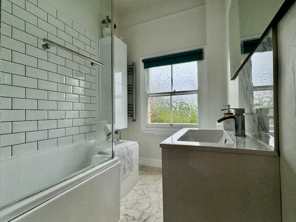 Family bathroom with shower over bath