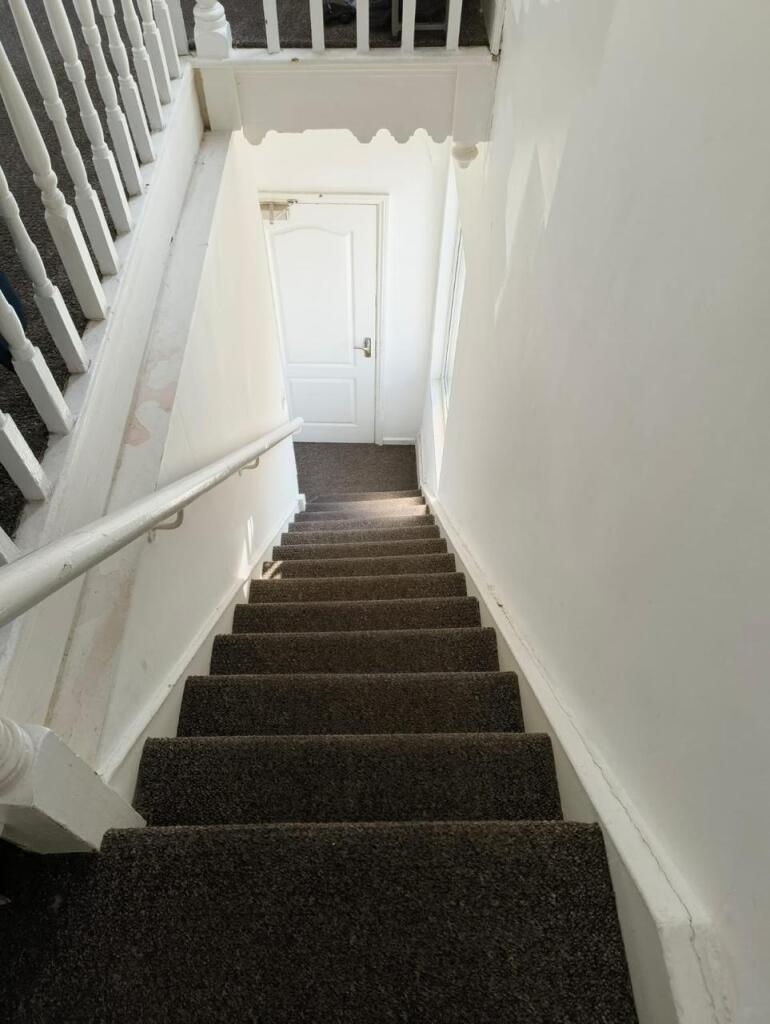Bright and clean staircase with white walls and...