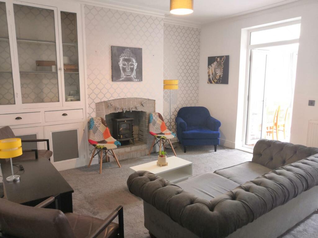 A spacious and well-decorated modern living roo...