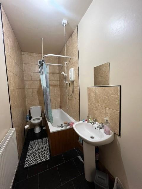 A clean and functional bathroom with a shower, ...