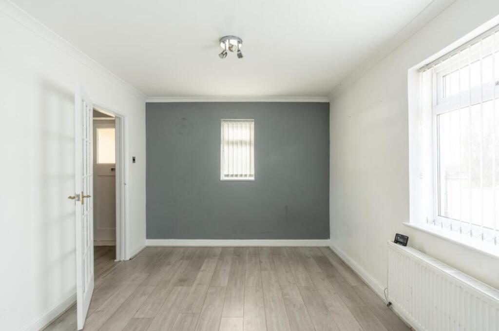 A bright and spacious living room with modern d...