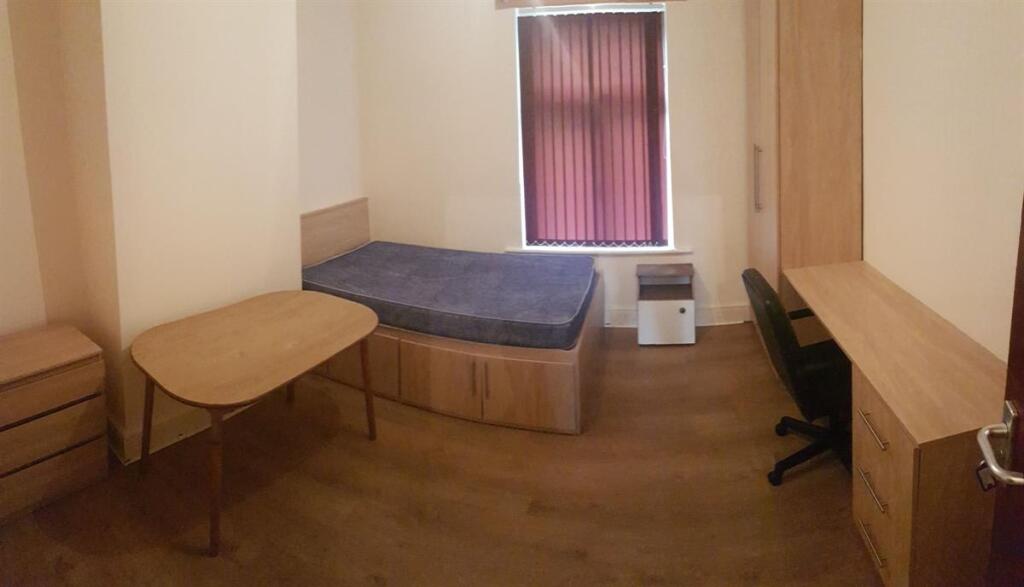 A compact, tidy private toilet area featuring a...