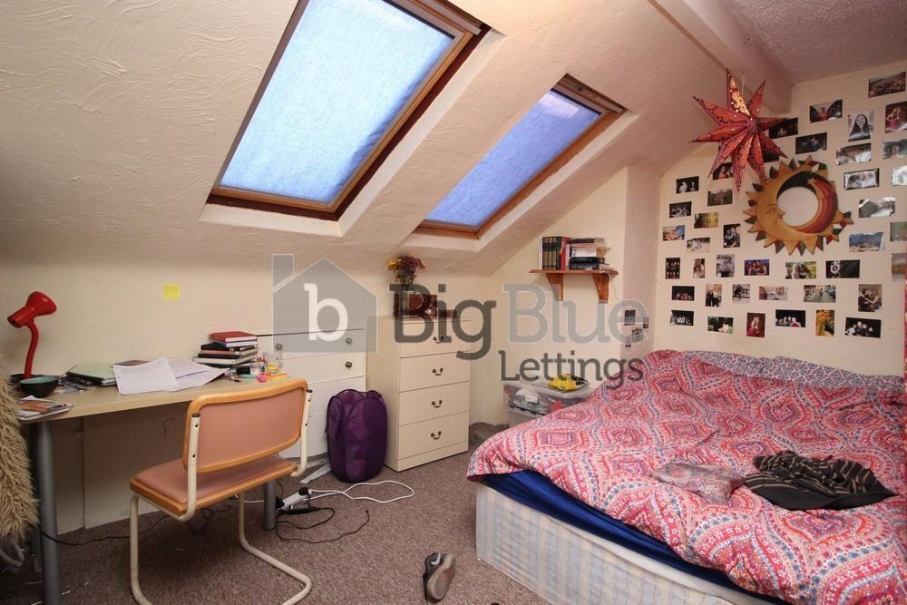Cozy single bedroom featuring a comfortable bed...