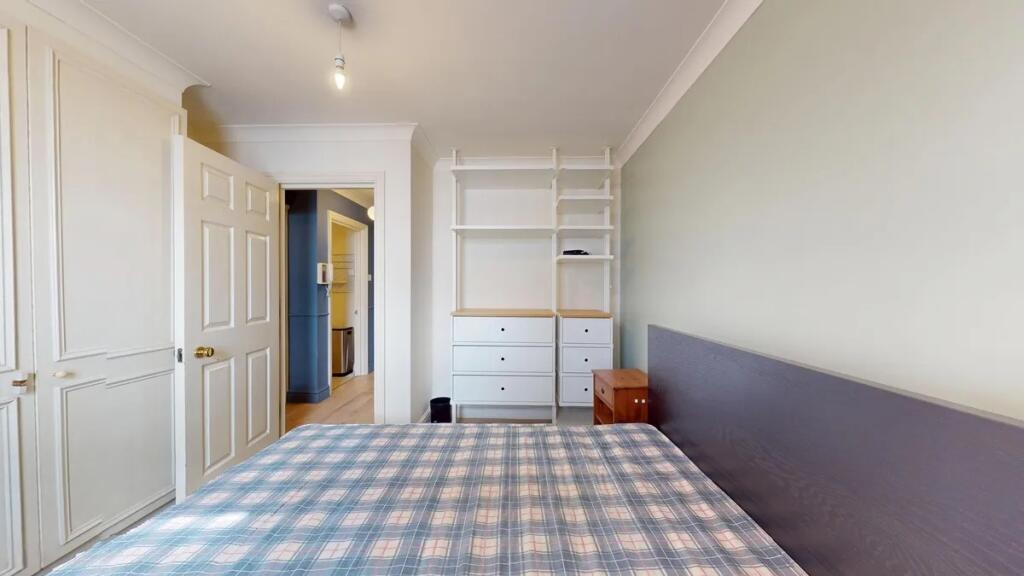 Bright and tidy double bedroom featuring a larg...