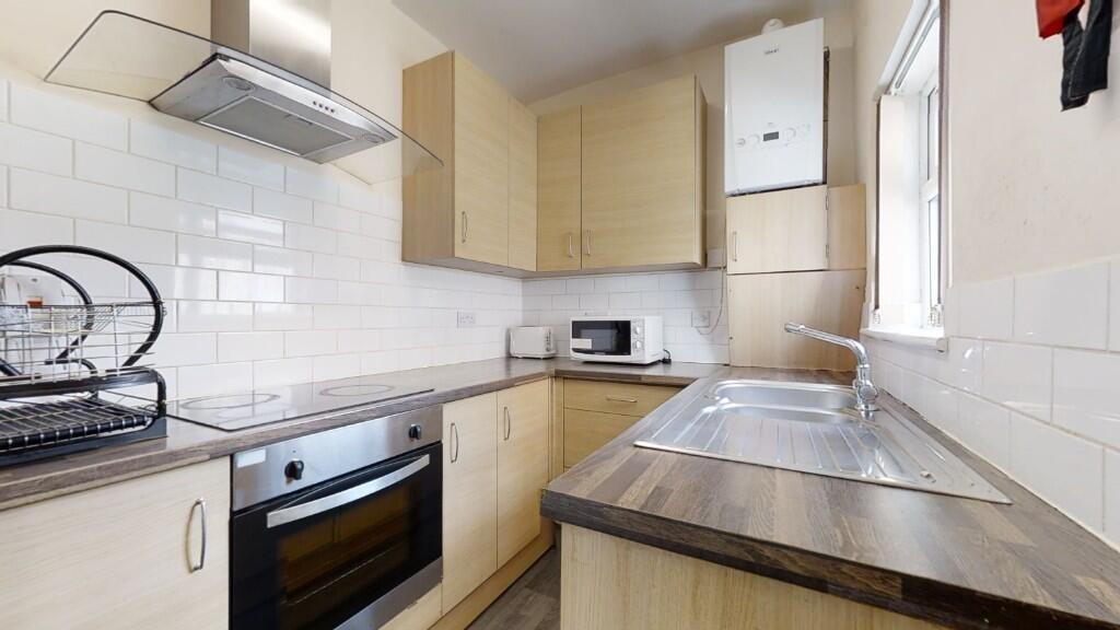 Bright and tidy kitchen featuring modern applia...