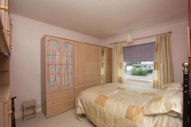 A cozy double bedroom featuring a comfortable b...