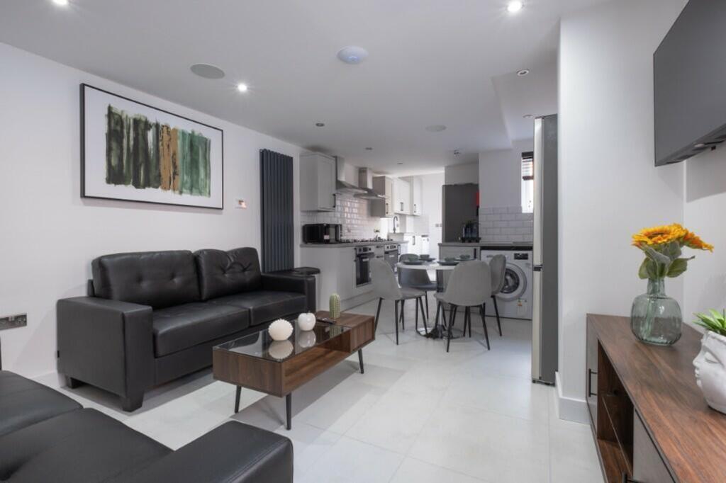 This stylish living room features a modern desi...
