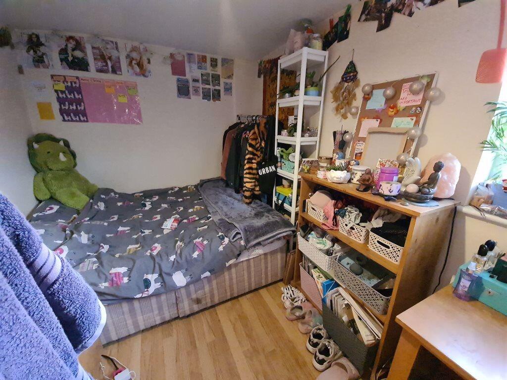 Cozy single bedroom featuring a comfortable bed...