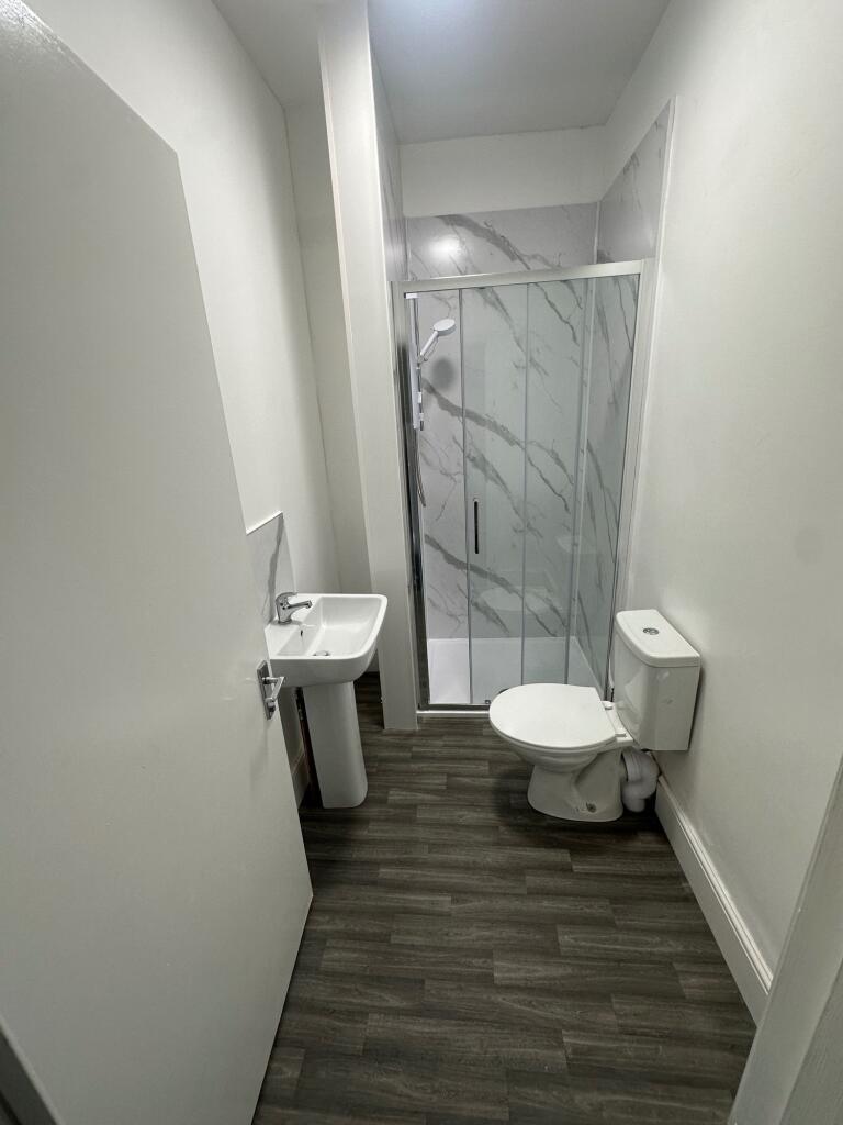 A modern bathroom featuring a sleek walk-in sho...