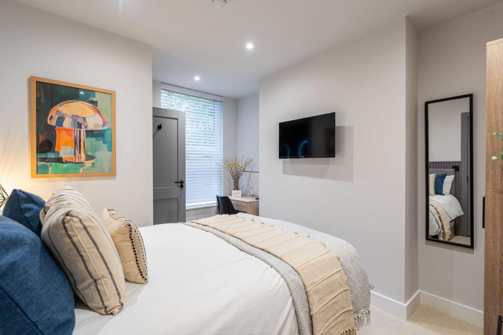 Bright and inviting bedroom featuring a neatly ...