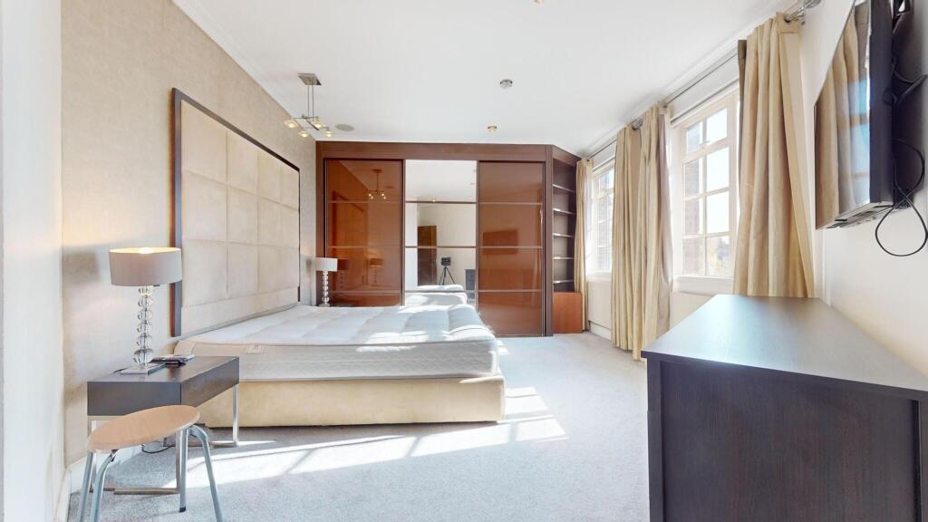 Bright and spacious master bedroom featuring a ...