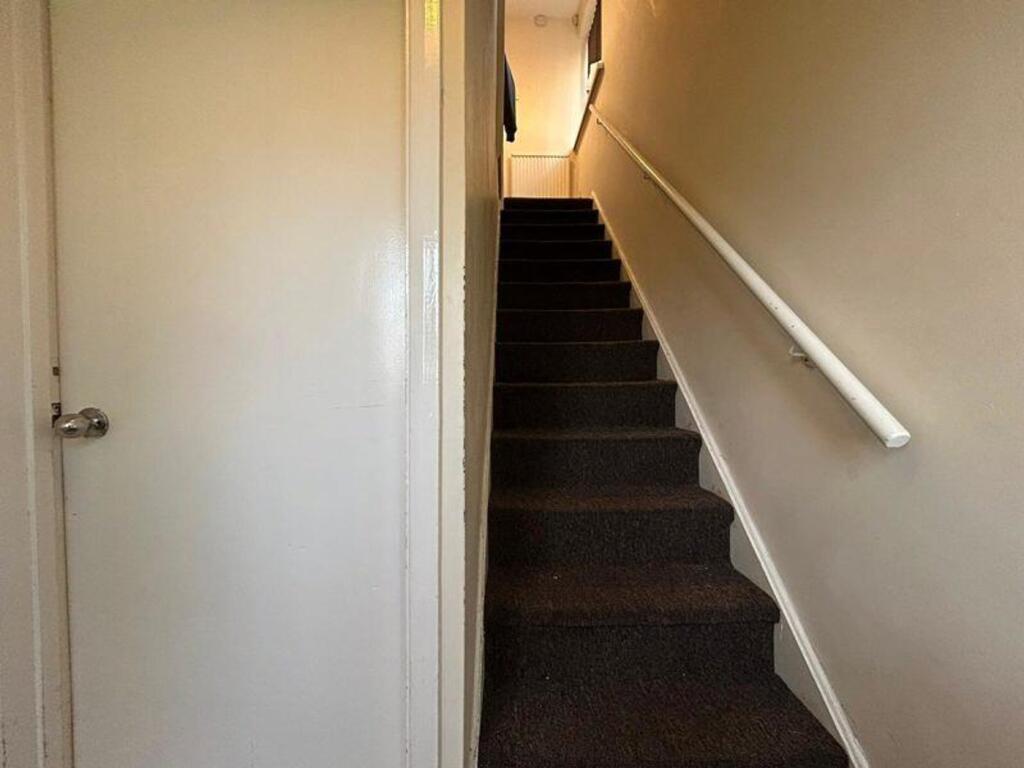 A well-maintained staircase leading to upper fl...