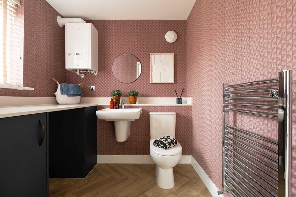 A combined cloakroom and utility adds convenience